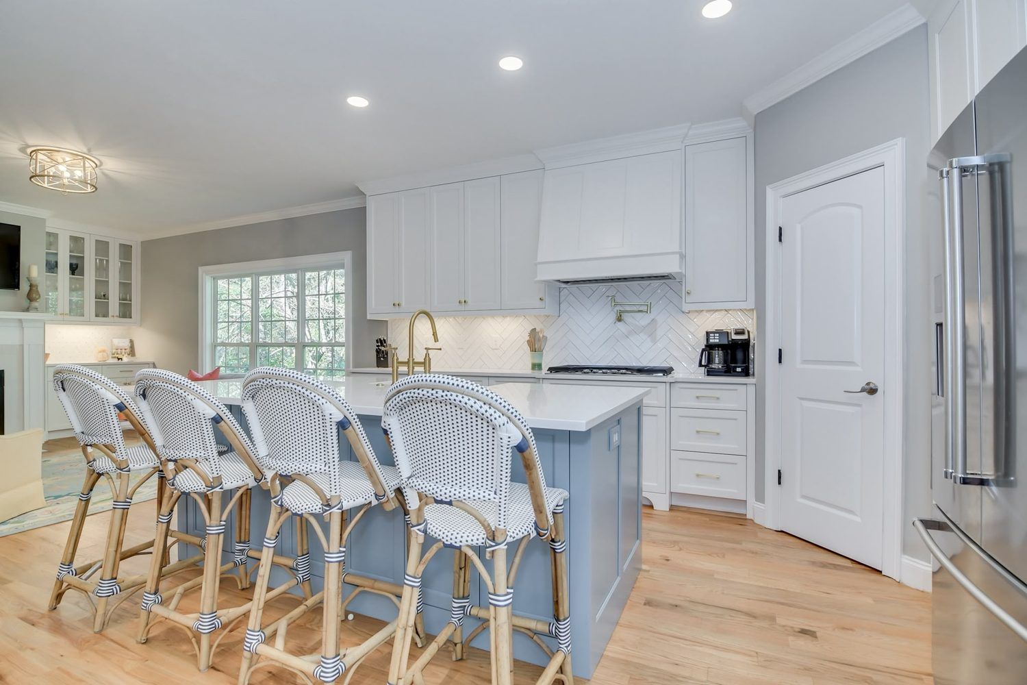 Remodeled kitchen with white cabinetry and quartz counters