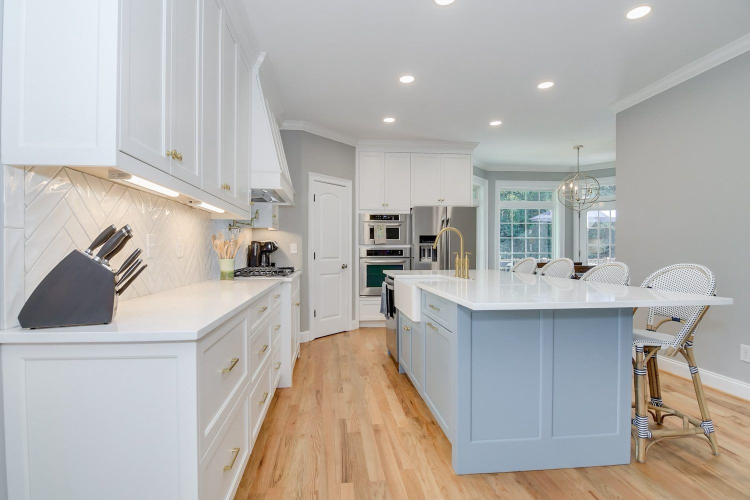 Kitchen with herringbone backsplash and a farmhouse sink